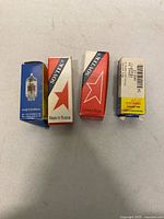 Four boxed vacuum tubes showing brand labels: JJ Electronic, two Sovtek, one JJ Electronic