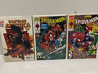 Group shot of three bagged comics: Captain America variant, Spider-Man #4, Spider-Man #5