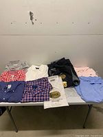 Overview of all folded shirts and jacket on table