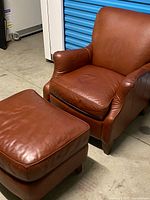 Front angle view of leather armchair and ottoman
