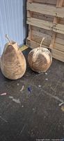 Pear and apple wooden sculptures side by side