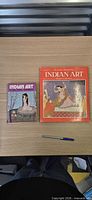 Front covers of both Indian Art books with pen for scale