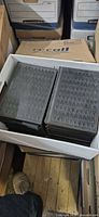 Two columns of matching black hardcover encyclopedia volumes in box