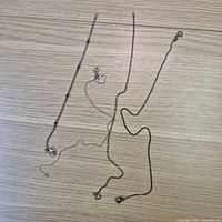 Four sterling silver anklets laid out on table