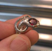 Close-up of snake ring coiled with red gemstone head