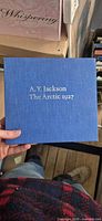 Front of blue cloth slipcase showing title and author