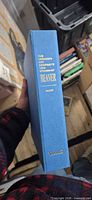 Spine of blue slipcase showing title and publisher