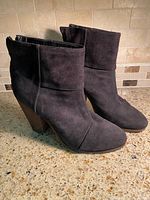 Side view of both suede ankle boots showing uppers and heel profile