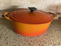 Dutch oven with lid showing flame gradient color and side handles