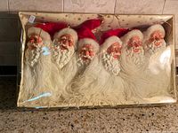 Box of six Santa head ornaments with clear lid in place
