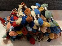 Pile of assorted colour Laine Colbert wool skeins with labels