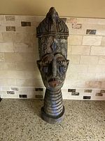 Full view of carved wood and metal tribal bust