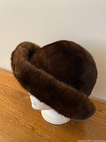 Right-side view of dark brown mink fur hat on mannequin