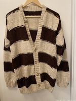 Full front view of cardigan on hanger