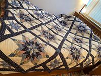 Full view of quilt on queen bed showing overall pattern and size