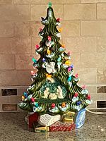 Tree unlit showing nativity base and bulbs