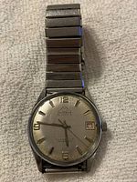 Full watch front including dial and bracelet