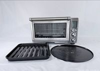 Oven with broil/drip tray and pizza pan displayed