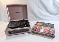 Turntable open with LP stack beside it