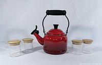 Kettle centered with four jars