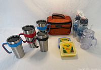 All items group shot showing tumblers, handles, Seychelle bottles, mason tumbler, Crayola containers, REI cooler