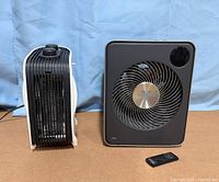 Front and side view of both heaters with remote on floor