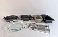 Group of pans, pie dish and cookie cutter set