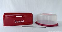 Bread box and cake carrier side by side with ruler for scale