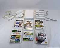 All bundle items laid out: console, four remotes, two Nunchuks, two Classic Controllers, sensor bar, six game cases