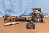 Both RIDGID saws, battery, blade case displayed