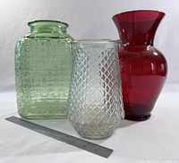 Group shot of three vases with ruler for scale