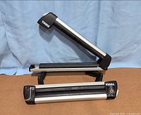 Both Thule carriers shown open and closed