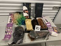 Group shot of all wigs and extensions on table