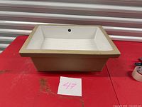 Overall view of sink showing rectangular shape and overflow opening