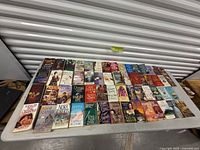 Single image showing all paperback novels laid out on a folding table