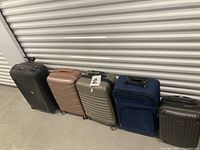 Five suitcases lined up showing colours and types