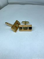 Pair of brass gold-tone cufflinks front and back