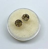 Pair of yellow tourmaline stud earrings in case, frontal view