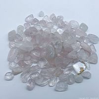 Pile of mixed rose and clear quartz tumbled stones
