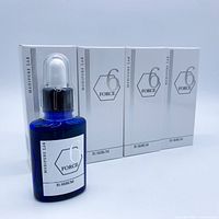 Front view showing one cobalt-blue serum bottle with dropper and three boxed units
