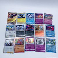 Group shot of all 15 Japanese Pokémon cards showing mix of holo and non-holo