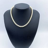 Full view of pearl strand on display bust