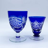 Two cobalt blue cut-to-clear goblets showing bowl, stem and clear foot