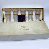 Five glasses in satin-lined box with booklet visible