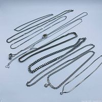 All ten silver-tone necklaces laid out for full overview