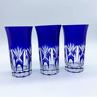 Front view of three cobalt blue Kiriko tumblers showing cut pattern