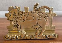 Front view showing cow design and base