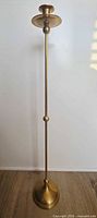 Full view of brass floor candle stand showing height, base, and top dish
