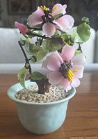 Front view of gemstone cherry blossom bonsai in celadon pot