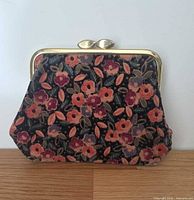 Front view of floral coin purse showing pattern and brass frame